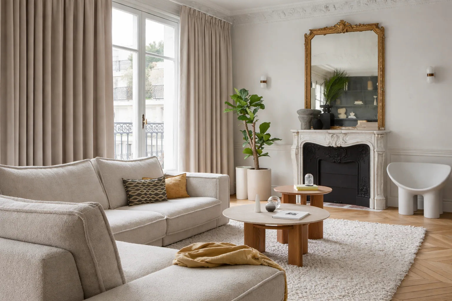 Haussmann sitting room with made-to-measure Qurtens beige blackout thermal acoustic curtains, marble fireplace with gilt mirror, cream bouclé sofa, sculptural armchair and herringbone parquet